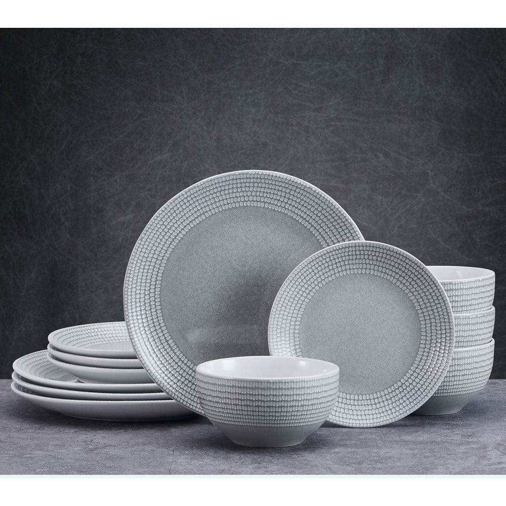 Close-up of handcrafted dot pattern on rim of dinner plate in Felicity set