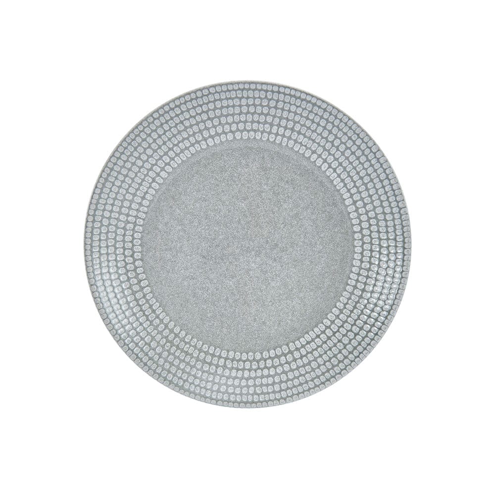 Close-up of handcrafted dot pattern on rim of dinner plate in Felicity set