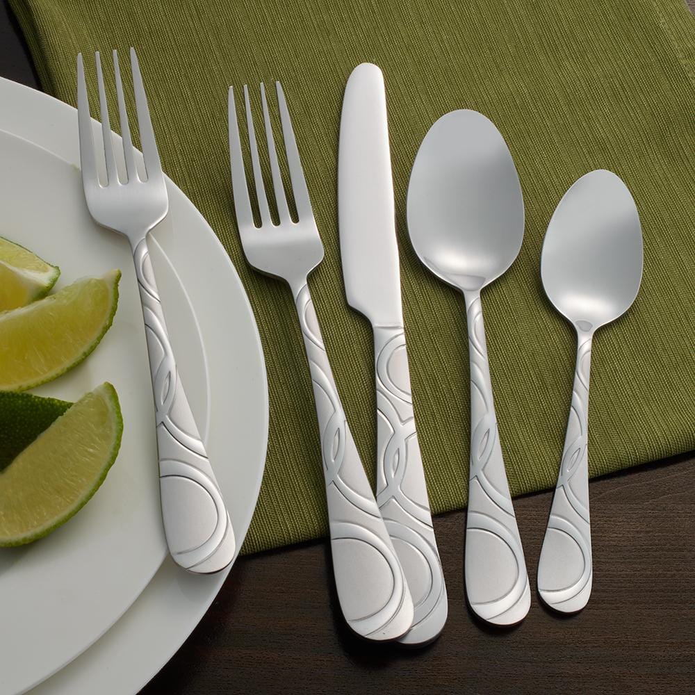 Garland Frost flatware set arranged on a dining table, showcasing the swirl design and satin finish.