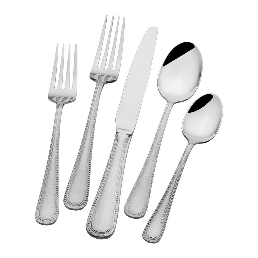 Set of stainless steel flatware arranged on a dining table