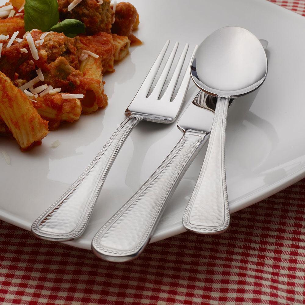 Serving spoon and fork included in the flatware set for dinner parties
