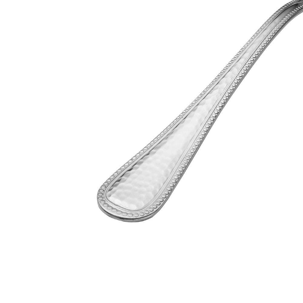 Set of stainless steel flatware arranged on a dining table