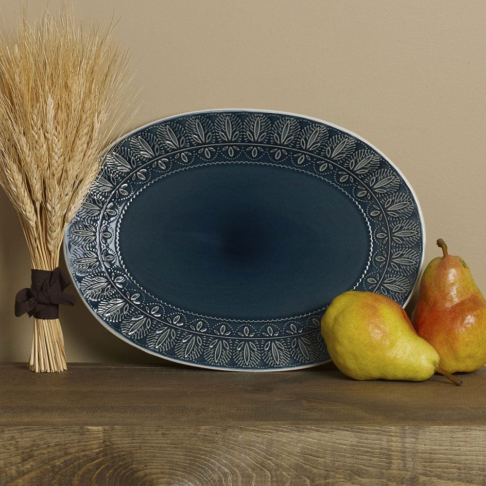 Blue stoneware oval platter with embossed design, ideal for serving at parties