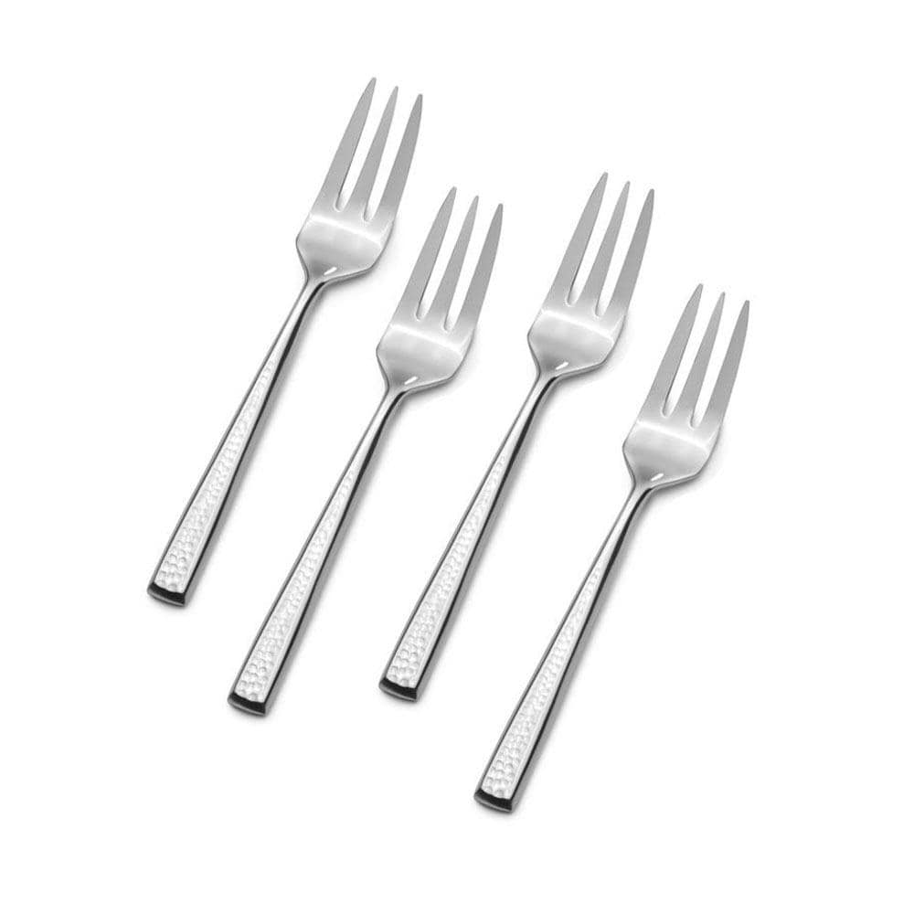 Close-up of a seafood fork being used to enjoy oysters