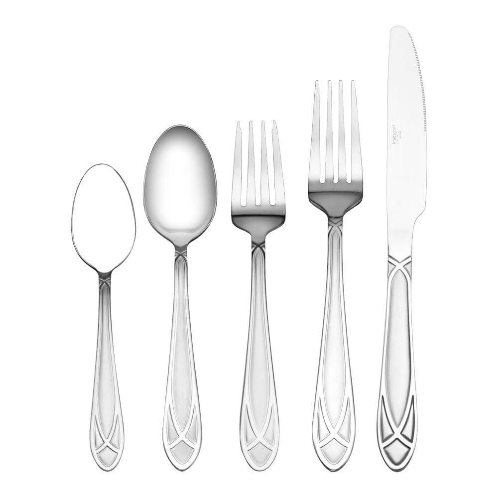 Flatware set for 8 arranged on a dinner table with wire caddy in the background