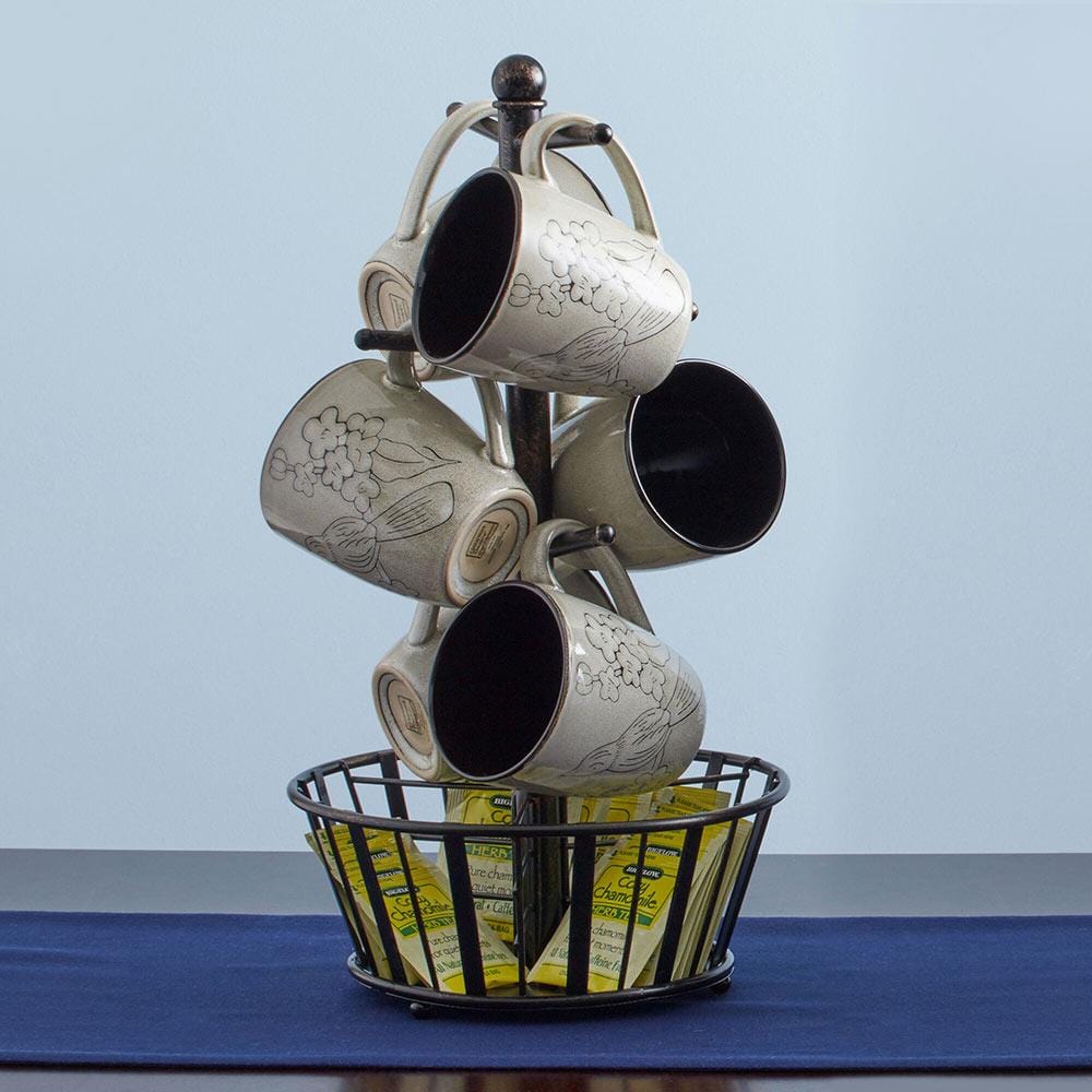 Close-up of black wrought iron mug tree with basket for coffee organization