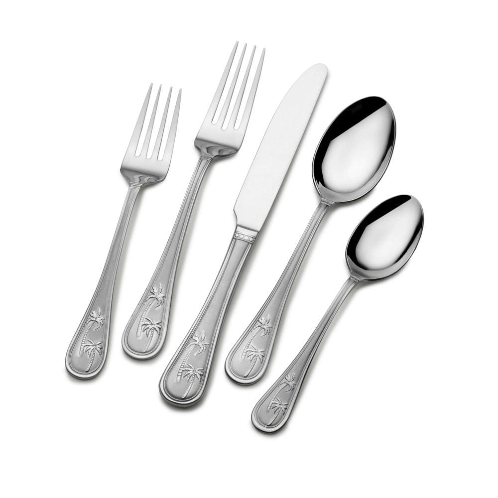 Close-up of the stainless steel cutlery highlighting the palm tree motif on the handles.