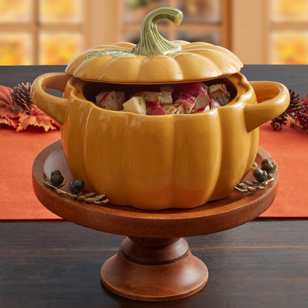 Large oven-safe casserole with lid filled with pumpkin casserole for Thanksgiving