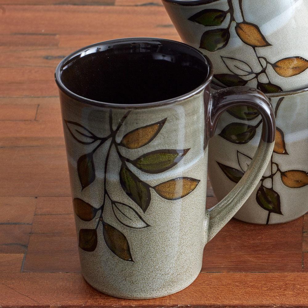 Close-up of reactive glaze on handcrafted stoneware latte mug highlighting unique color variations