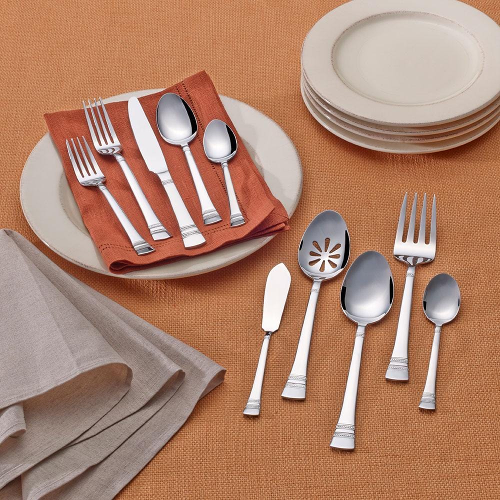 Close-up of stainless steel silverware with modern design handles, suitable for service for 8