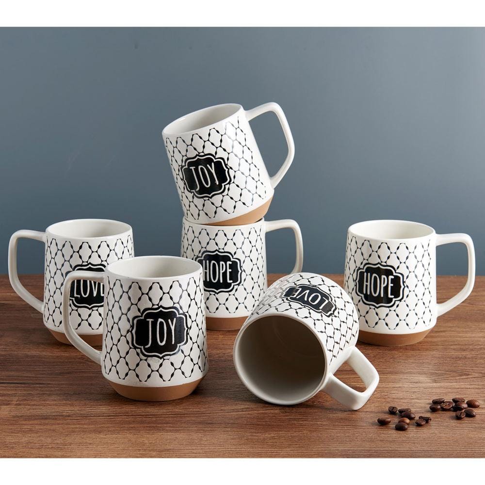 Set of 6 decorative coffee mugs arranged on a kitchen table, showcasing their unique sentiments.