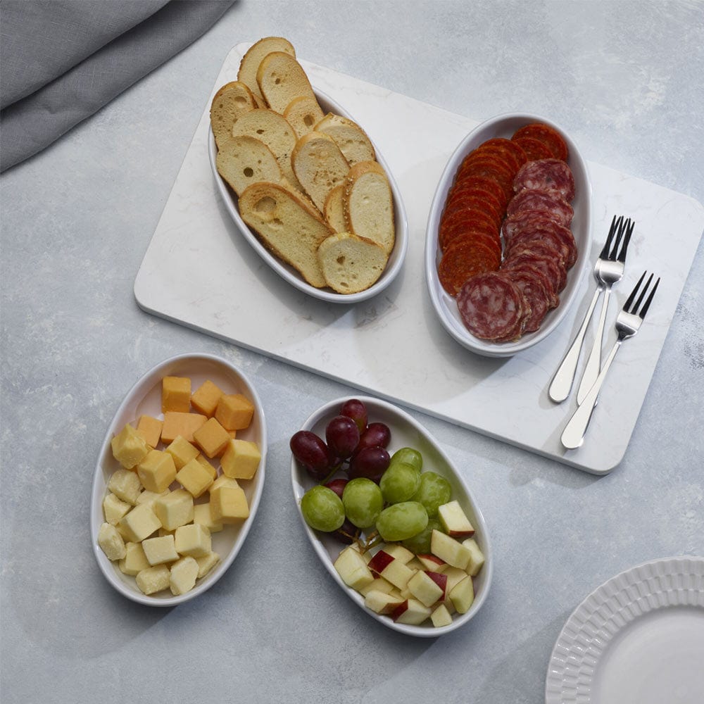 Elegant oval serving bowls for parties, filled with delicious burritos and garnished with toppings.