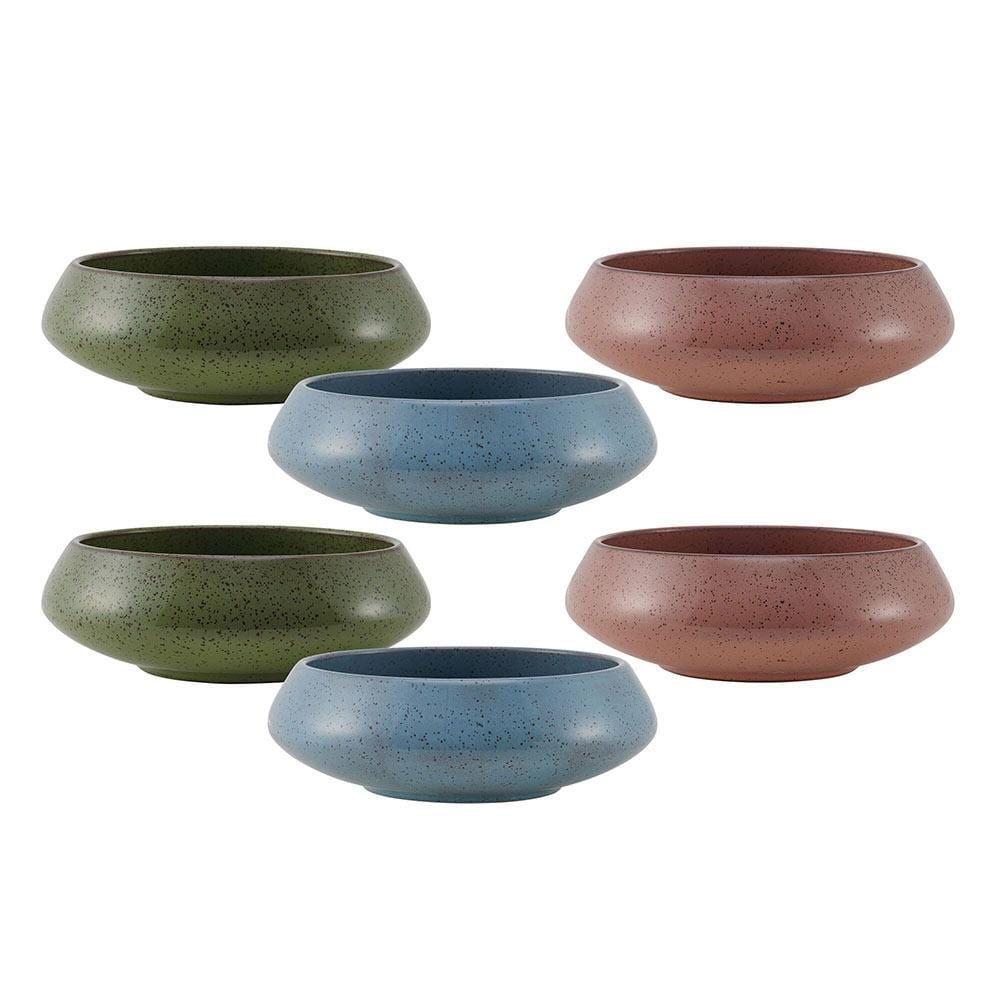 Handcrafted colorful speckled bowls in pink, blue, and green arranged on a wooden table.