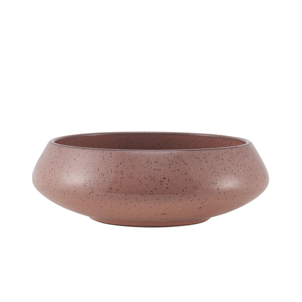 Handcrafted colorful speckled bowls in pink, blue, and green arranged on a wooden table.
