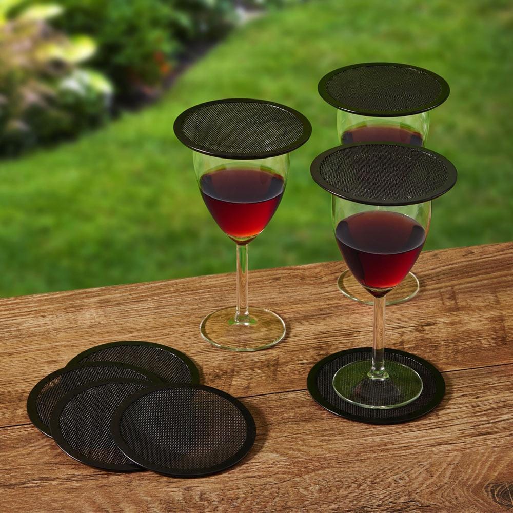Stylish beverage protectors set on a picnic table, showcasing their mesh design.