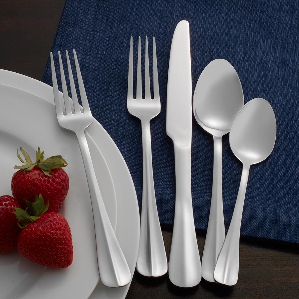 Elegant 53-piece stainless steel cutlery set arranged on a dining table.