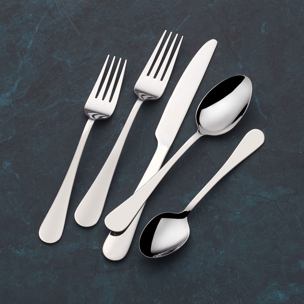 Elegance 20-Piece Stainless Steel Cutlery Set displayed on a dining table, showcasing its mirror finish and elegant design.