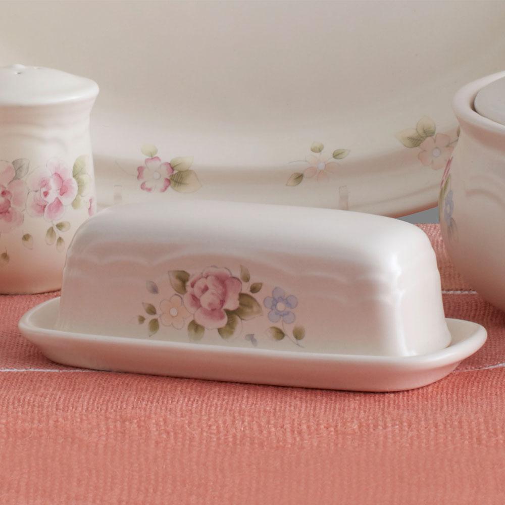 Overhead view of tea rose butter dish with lid off, showcasing butter storage inside this stoneware dish.