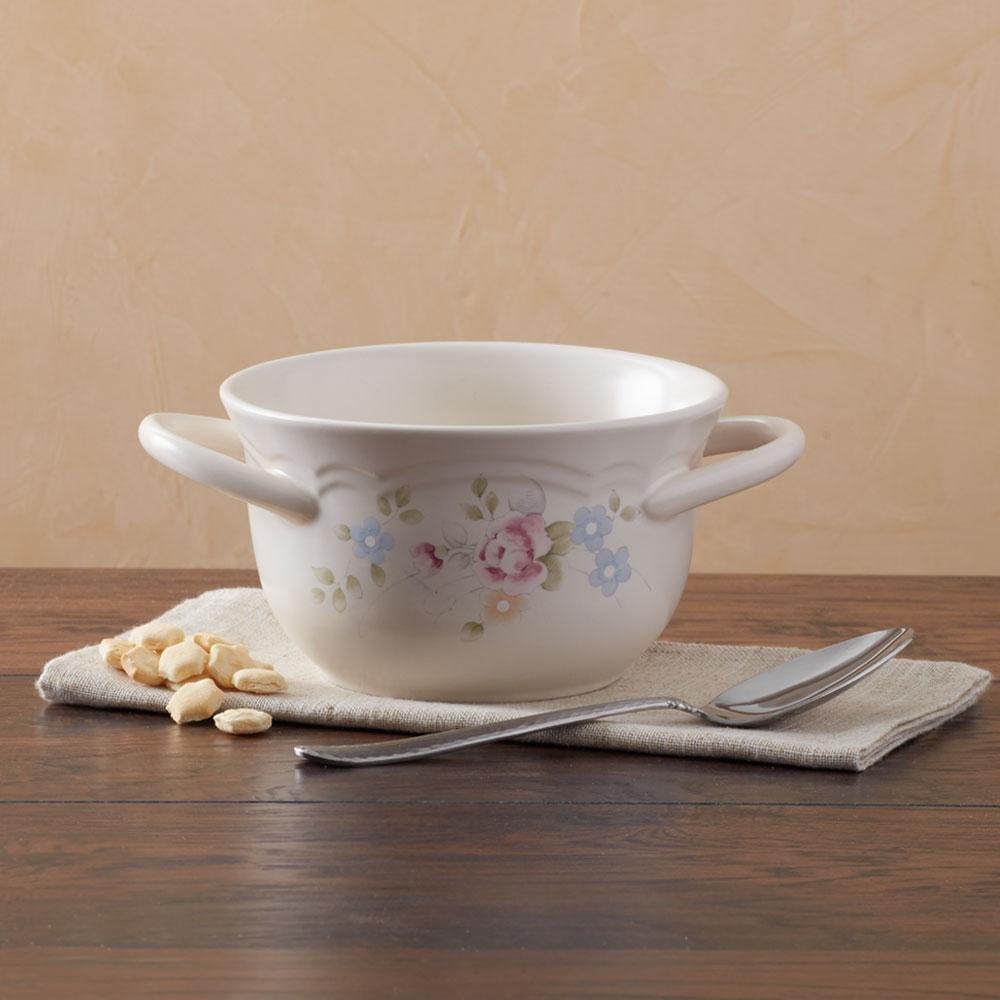 Elegant double handled stoneware bowl filled with chili, showcasing the comfortable grip.