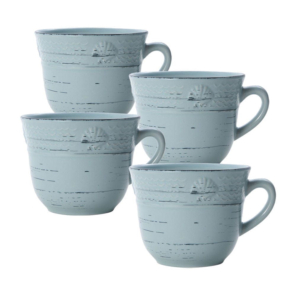 Overhead view of embossed teal mug set on rustic kitchen counter