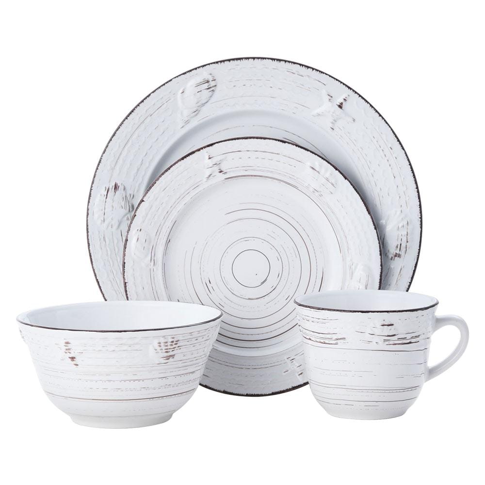 Coastal Charm dinner plates with seashell designs on a rustic table setting.