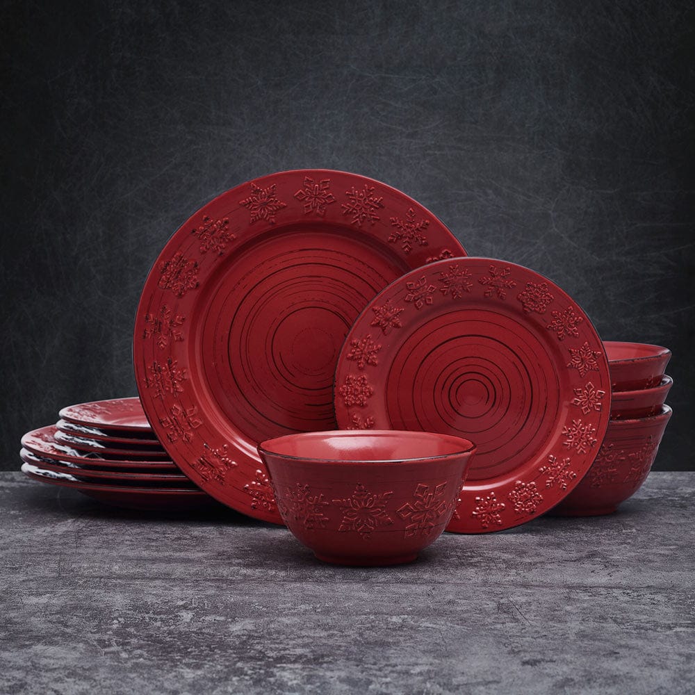 Rustic Trellis Snowflakes Dinnerware Set featuring dinner plates, salad plates, and bowls with snowflakes design on a red background.