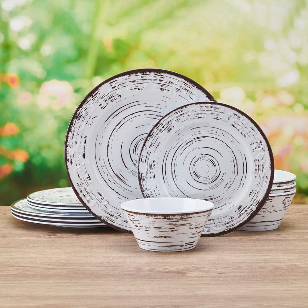 Overhead view of Trellis White melamine dinnerware set arranged on a patio table with summer decor