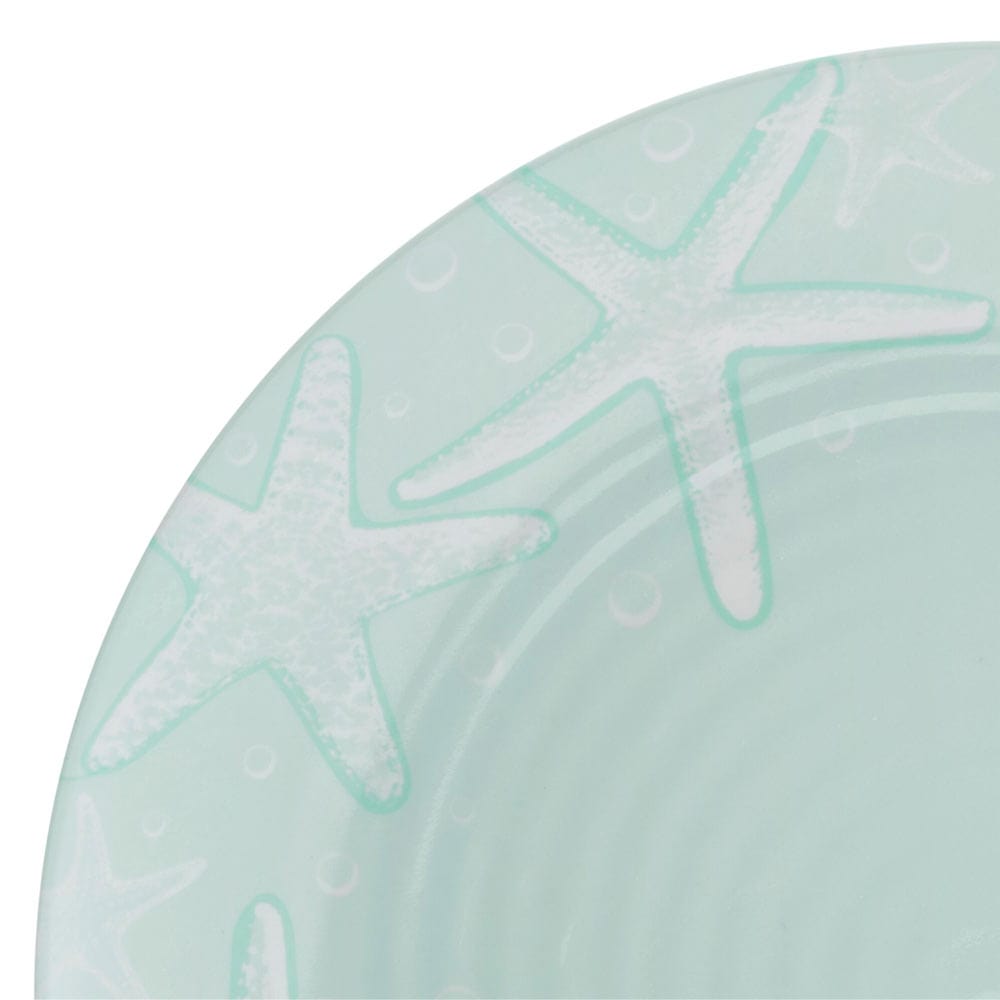 Close-up of the teal melamine plates and bowls showcasing their sturdy design and beach-themed artwork.
