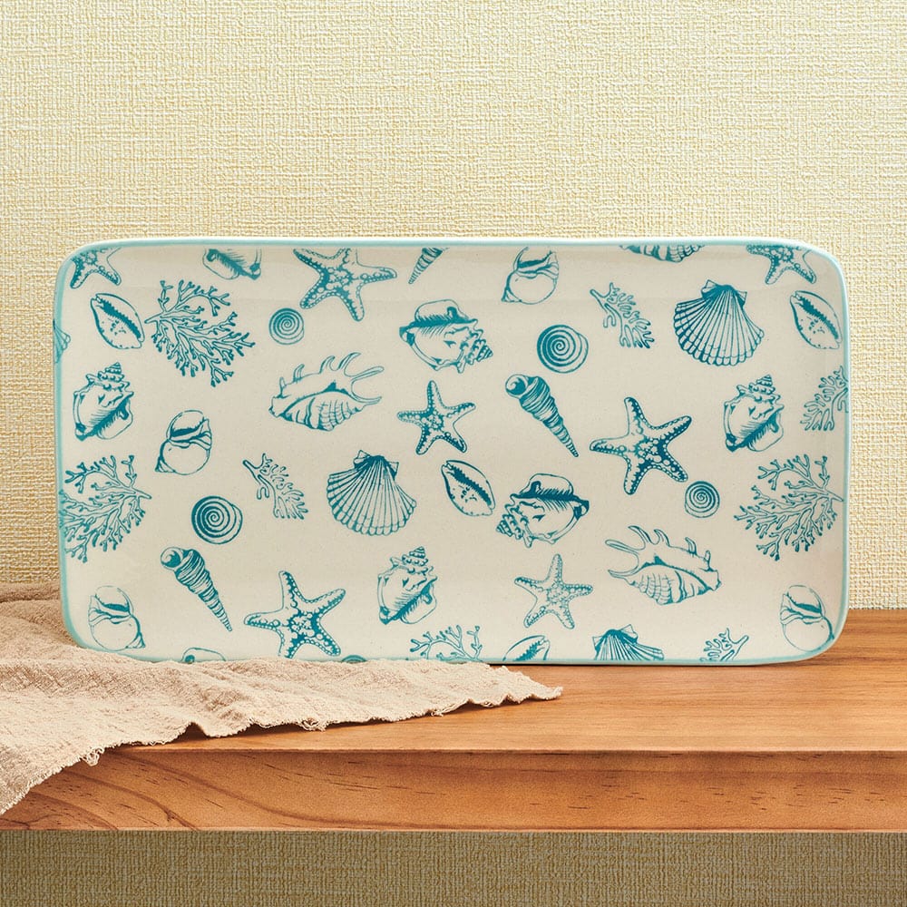 Coastal Charm Stoneware Serving Platter showcasing starfish and seashell design from above.
