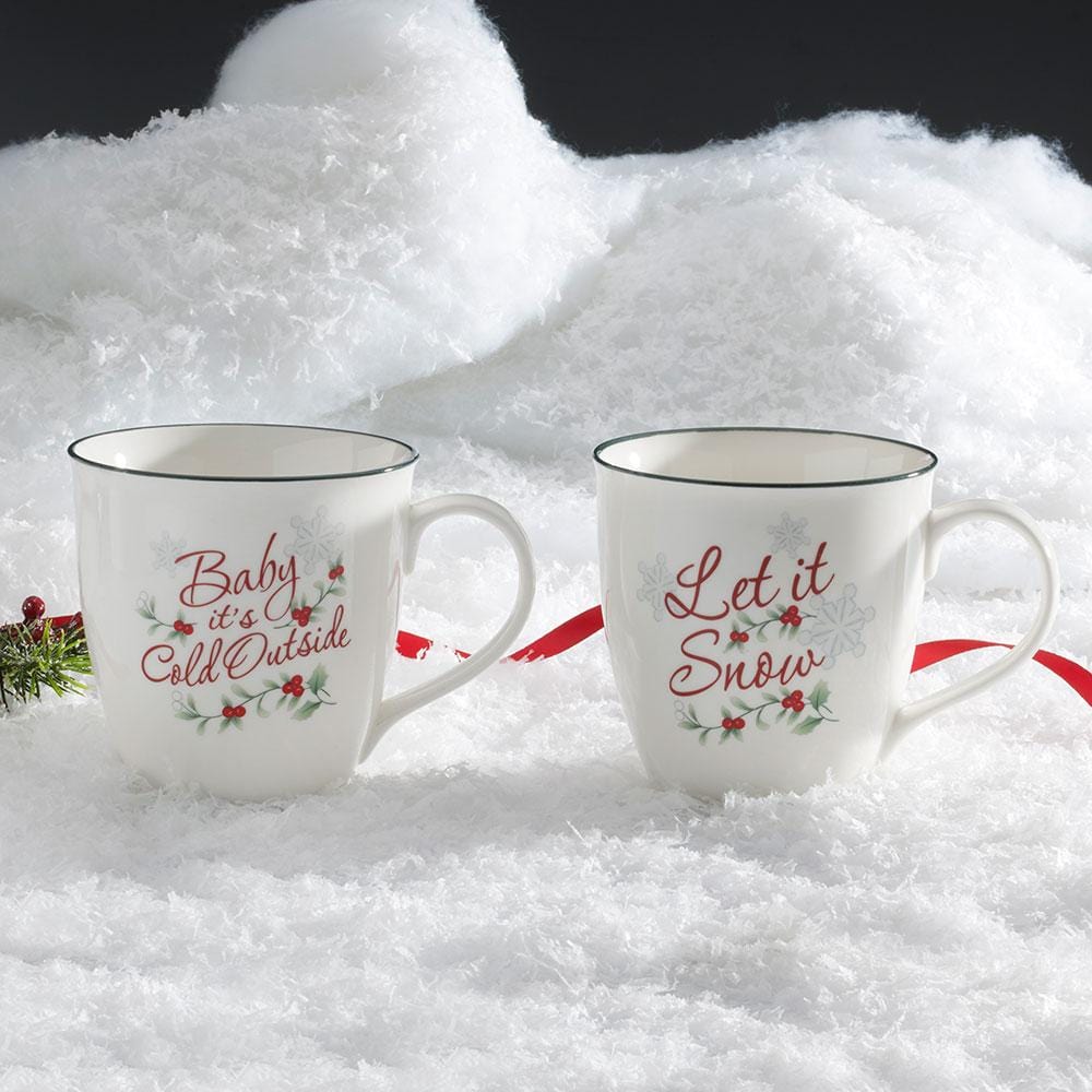 Close-up of winter-themed porcelain mug with snowflakes and 'Let It Snow' design