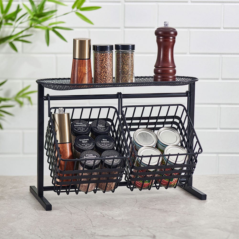 A side view of the top rated black metal fruit basket showcasing two tiers filled with fresh produce.