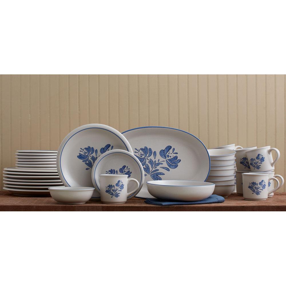 Stoneware dinnerware set for 8 with plates and bowls arranged on a dining table